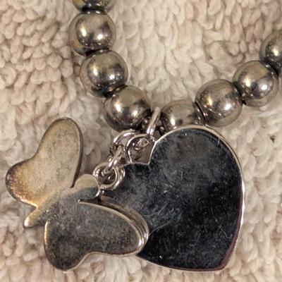 "Truly Inspired" silver-plated adjustable bracelet with a butterfly charm made with Swarovski® crystals.