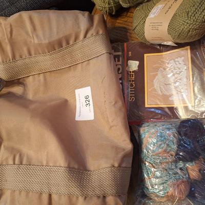 assortment of knitting or crocheting supplies, needles, little bit of yard and a few patterns