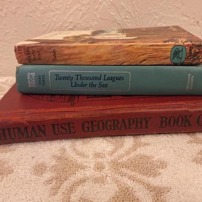 Huckleberry Finn, Twenty Thousand Leagues Under the Sea and Human Use Geography books.