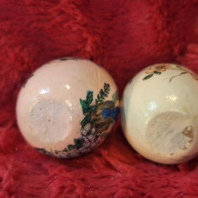 two hand painted wooden eggs with birds and flowers