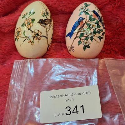 two hand painted wooden eggs with birds and flowers