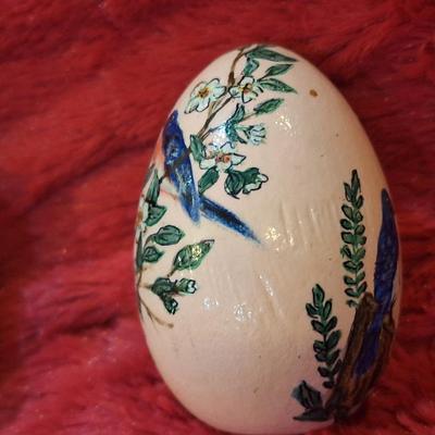 two hand painted wooden eggs with birds and flowers