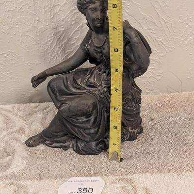 cast metal spelter clock topper of woman seated, Greek goddess maybe? Diana Artemis or Pandora? We aren't sure.