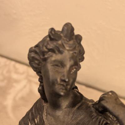 cast metal spelter clock topper of woman seated, Greek goddess maybe? Diana Artemis or Pandora? We aren't sure.