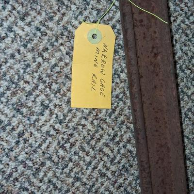 A PIECE OF RAILROAD TRACK, PIECE OF NARROW GAGE MINE RAIL AND MORE