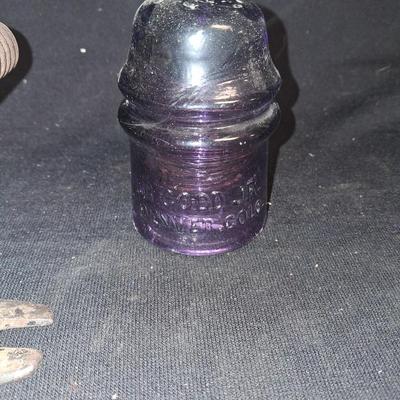 PURPLE GLASS INSULATOR AND AN IRON PERCH