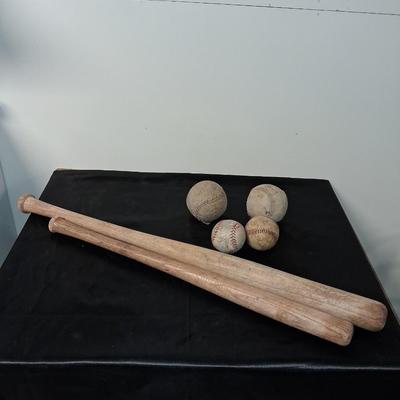 2 VINTAGE BASEBALL BATS AND SOME BALLS