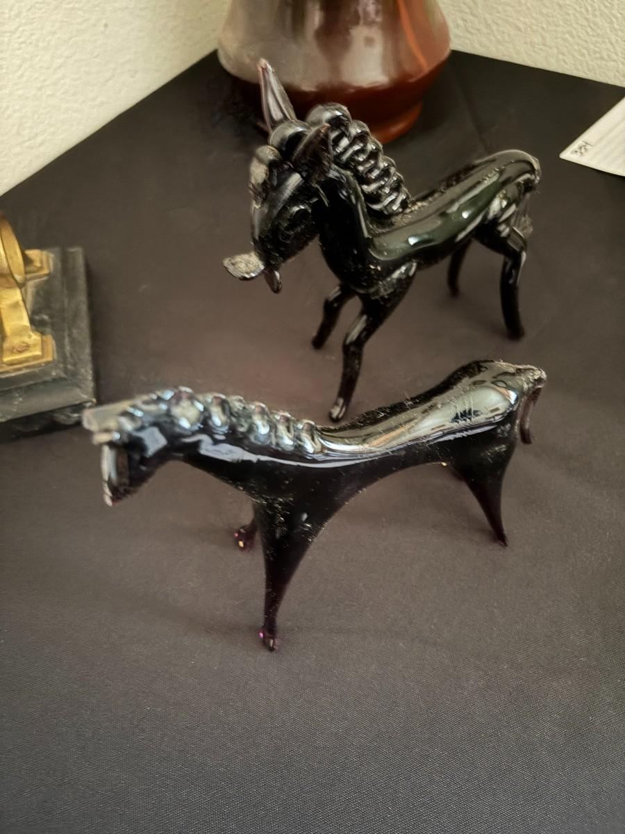 2 purple glass horses