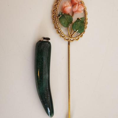 Sale Photo Thumbnail #324: This lot is for two items of Vintage Jade Jewelry.  The first item is a stick pin made with jade leaves and pink stone roses on a metal goldtoned holder. The other item is a horn-shaped jade pendant.  Either would look great worn as a fashion statement.