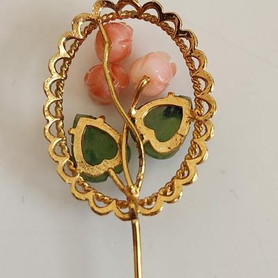 Sale Photo Thumbnail #319: This lot is for two items of Vintage Jade Jewelry.  The first item is a stick pin made with jade leaves and pink stone roses on a metal goldtoned holder. The other item is a horn-shaped jade pendant.  Either would look great worn as a fashion statement.