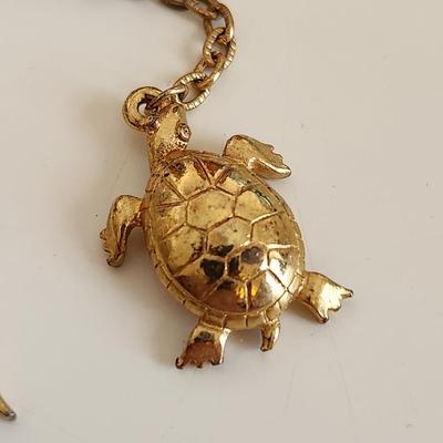Sale Photo Thumbnail #328: This lot is for an unusual Jewelry Whatsit.  This grouping of interesting items include a Jade (?) Stone Crab Claw, a Turtle and a Salamander all chained and hooked together. Nice dangley jewel for any fashionista. Or for any other purpose one might devis