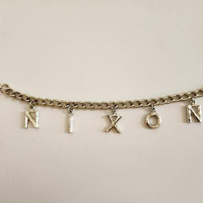 Sale Photo Thumbnail #331: This lot is for a grouping of Nixon 1992 Campaign Items.  This lot includes a nifty Nixon bracelet in a goldtoned metal and two small label pins. Very unusual.