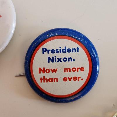 Sale Photo Thumbnail #335: This lot is for a grouping of Nixon 1992 Campaign Items.  This lot includes a nifty Nixon bracelet in a goldtoned metal and two small label pins. Very unusual.