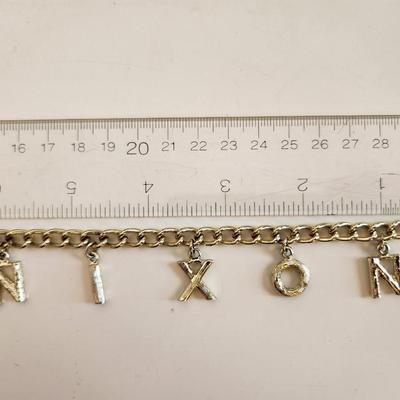 Sale Photo Thumbnail #332: This lot is for a grouping of Nixon 1992 Campaign Items.  This lot includes a nifty Nixon bracelet in a goldtoned metal and two small label pins. Very unusual.