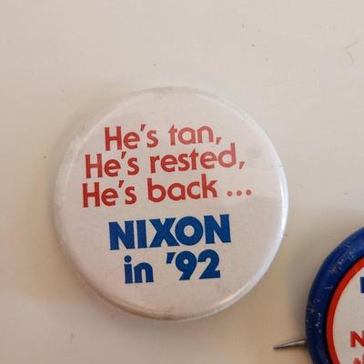 Sale Photo Thumbnail #334: This lot is for a grouping of Nixon 1992 Campaign Items.  This lot includes a nifty Nixon bracelet in a goldtoned metal and two small label pins. Very unusual.