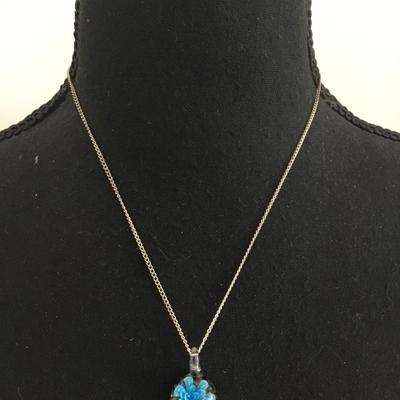 Glass pendant and silver tone chain