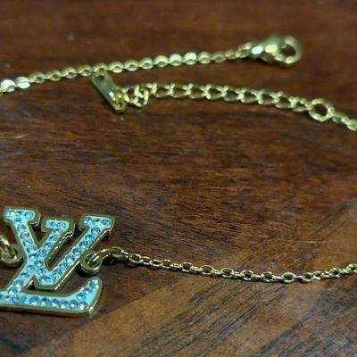 Louis Vuitton rhinestone initial bracelet 18 karat gold overlays stainless steel