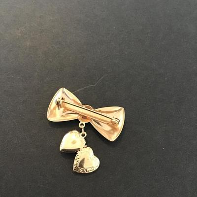Sale Photo Thumbnail #187: Vintage gold tone bow brooch with dangling heart locket 
Please see attached pictures