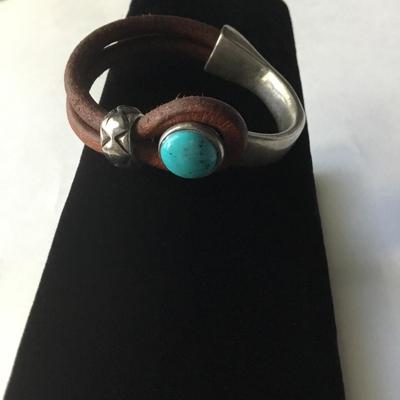 Bohemian leather type silver tone half cuff bracelet with a turquoise cabochon stone type