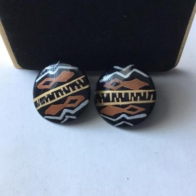Handmade round black button stud earrings with an ethnic or tribal inspired geometric pattern in white brown/orange