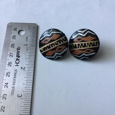 Handmade round black button stud earrings with an ethnic or tribal inspired geometric pattern in white brown/orange