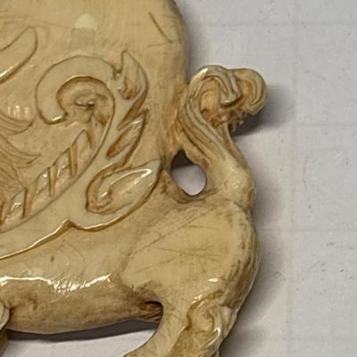 Bone carved pendant on leather necklace