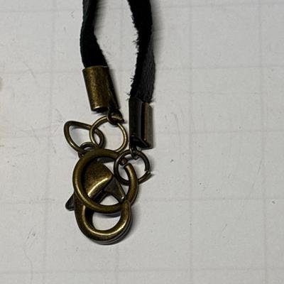 Bone carved pendant on leather necklace