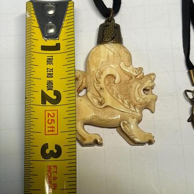 Bone carved pendant on leather necklace