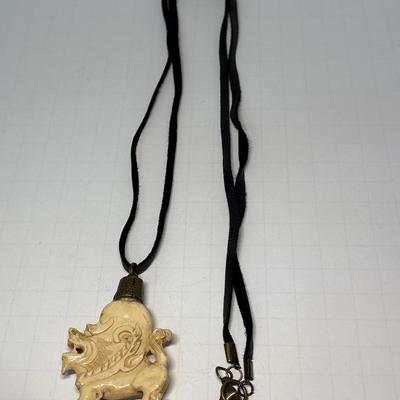 Bone carved pendant on leather necklace