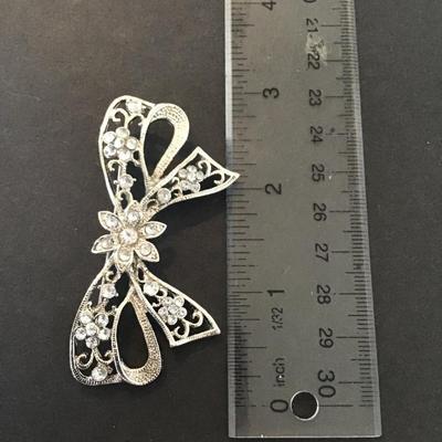 Sale Photo Thumbnail #49: Vintage silver tone rhinestone bow brooch Please see attached pictures