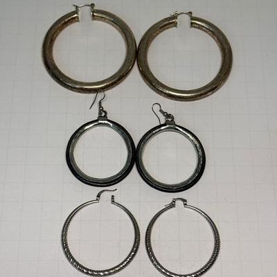 Three silver-tone earrings