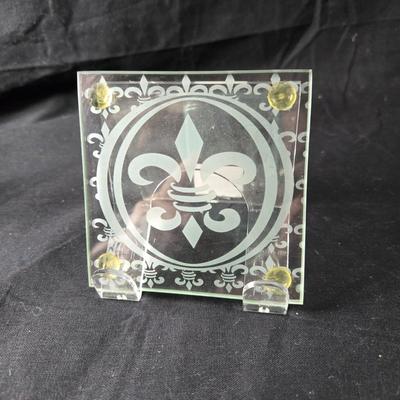 Sale Photo Thumbnail #380: This is s grouping of Fleur de Lis Items that could be used for entertaining.  It includes 2 etched glass coasters and a package of 2 silicone ice cube trays.  All items are new and never used.  The final picture is of the coaster outside of it's box.