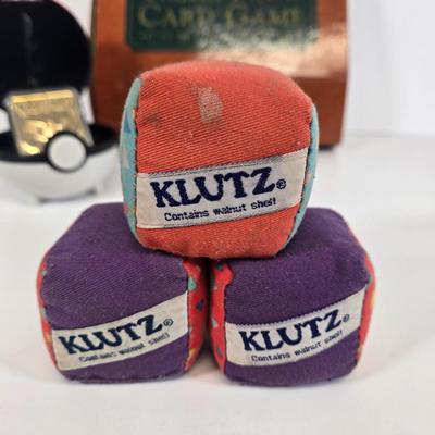 LOT 133: Ultimate Dice & Card Game Compendium, Pokémon 23k Gold Plated Trading Card, Unpunched Sheet of Official Magic: The Gathering...