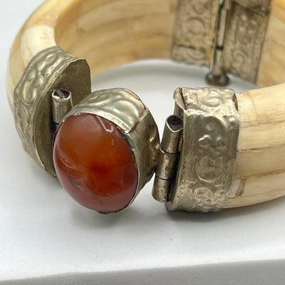 LOT 182J: Bracelet and Ring Collection featuring a Tibetan carved bone and Carnelian hinged bangle bracelet.