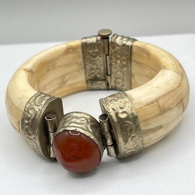 LOT 182J: Bracelet and Ring Collection featuring a Tibetan carved bone and Carnelian hinged bangle bracelet.