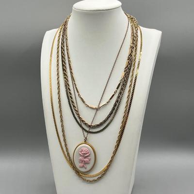 LOT 188: Collection of Gold Toned Necklaces Including One with Large Flower Pendant
