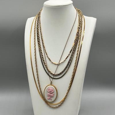 LOT 188: Collection of Gold Toned Necklaces Including One with Large Flower Pendant