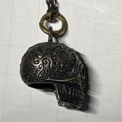 Silver skull pendant on chain