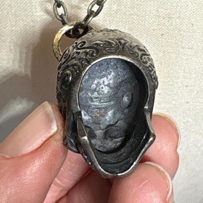 Silver skull pendant on chain