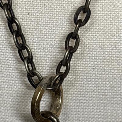 Silver skull pendant on chain