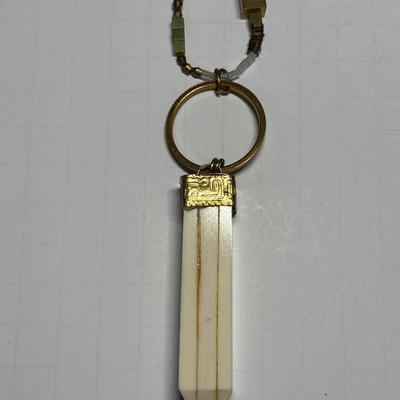 Ivory colored obelisk pendant in beaded chain