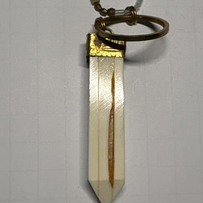 Ivory colored obelisk pendant in beaded chain