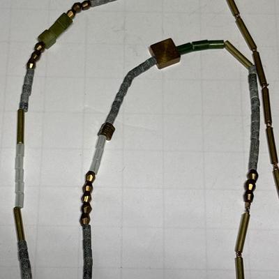 Ivory colored obelisk pendant in beaded chain