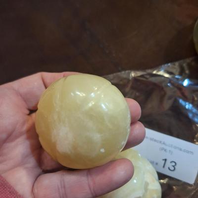 polished onyx fruit, 1 is an apple- the other two maybe a tomato?  We don't know.