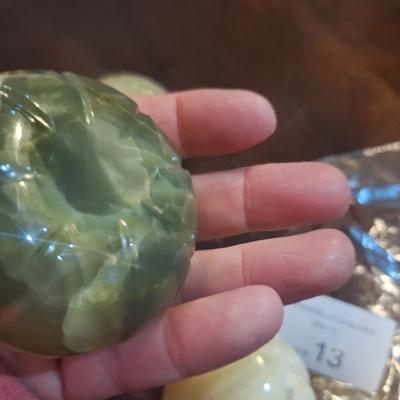 polished onyx fruit, 1 is an apple- the other two maybe a tomato?  We don't know.