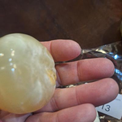 polished onyx fruit, 1 is an apple- the other two maybe a tomato?  We don't know.