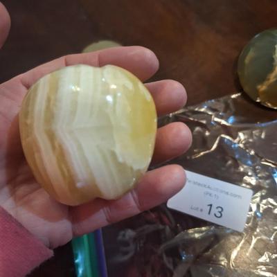 polished onyx fruit, 1 is an apple- the other two maybe a tomato?  We don't know.