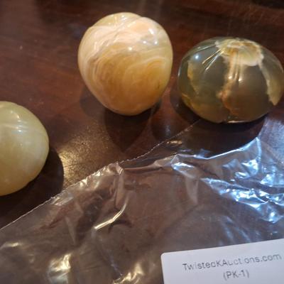 polished onyx fruit, 1 is an apple- the other two maybe a tomato?  We don't know.