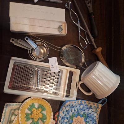 mixed lot of kithcen items. Cheese grater, cake tester, pot holders etc See photos