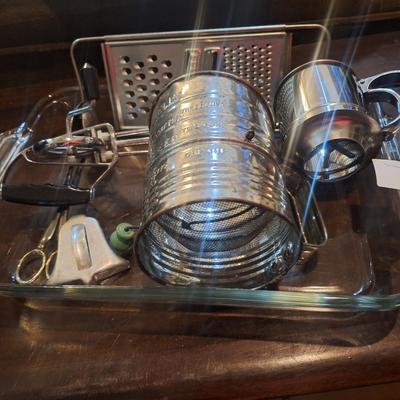 Cake pan, flour sifter, egg beater, cheese grater and other items